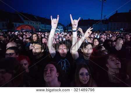 SIBIU, ROMANIA - JULY 26, 2019: Crowd of people headbanging and partying during rock concert at Artmania Festival