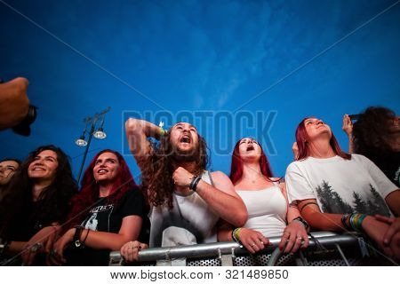 SIBIU, ROMANIA - JULY 26, 2019: Crowd of people headbanging and partying during rock concert at Artmania Festival