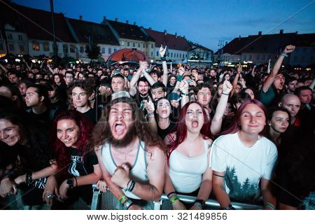 SIBIU, ROMANIA - JULY 26, 2019: Crowd of people headbanging and partying during rock concert at Artmania Festival