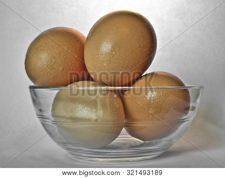 Brown Eggs In Transparent Bowl With Drops Of Moisture From Condensation.