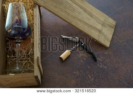 Red Wine Glass With Wine In Wooden Box