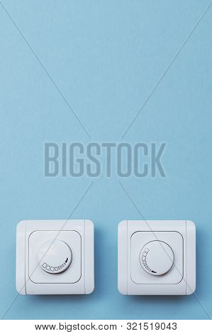 Dimmer Light Switch. Electrician Switch. White Rolling Electricity Switch On Bright Wall