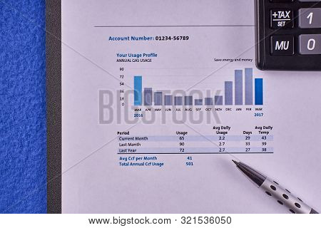 Communal Payments. Gas Supply Invoice With Calculator And Pen On A Blue Velvet Background. Close-up