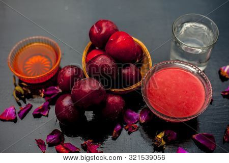 Plum Pulp Well Mixed With Water & Honey In A Glass Bowl Along With Raw Plums Or Prunes Or Aloo Bukha