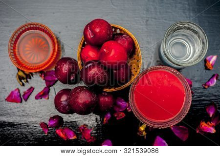Plum Pulp Well Mixed With Water & Honey In A Glass Bowl Along With Raw Plums Or Prunes Or Aloo Bukha