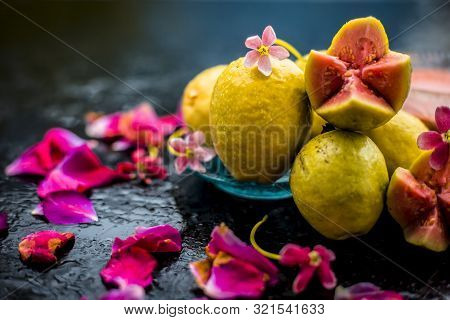 Raw Organic Guava Or Amrut Or Amarood In Hindi Language On Black Shinny Surface In A Blue-colored Pl