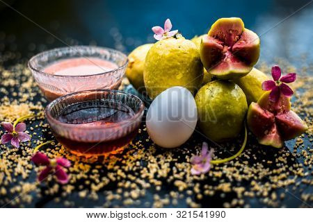 Treatment Of Dry Skin With The Help Of Face Mask On A Wooden Surface Consisting Of Honey, Guava Pulp