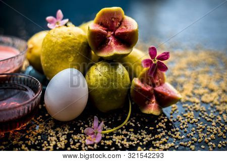 Treatment Of Dry Skin With The Help Of Face Mask On A Wooden Surface Consisting Of Honey, Guava Pulp