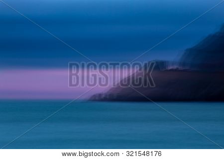 Artisitic Headland Coming Down To Sea At Dusk
