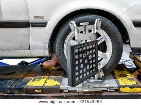 B-quik Auto Mechanic Shop At Bigc Petchkasem Performs Wheel Alignment Procedure On A Older Model Toy