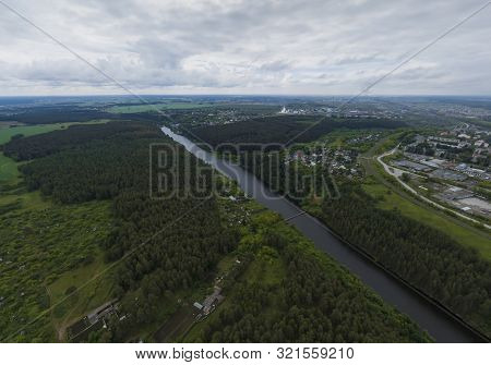 Sukhoy Log City, Pyshma River And Dark Forest. Russia, Aerial, Cloudu Day
