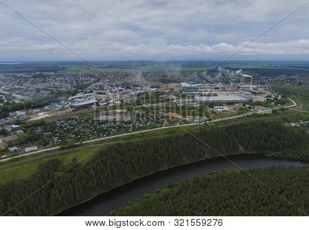 Sukhoy Log City, Pyshma River, Dark Forest And Cement Factory. Russia, Aerial, Cloudu Day