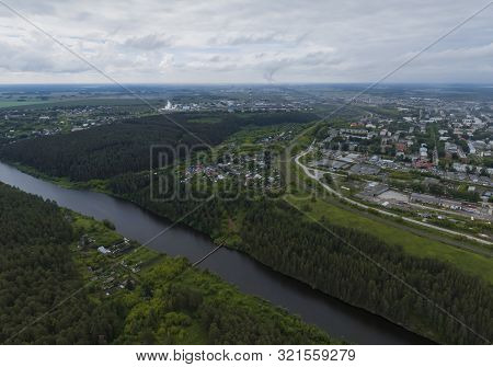 Sukhoy Log City, Pyshma River And Dark Forest. Russia, Aerial, Cloudu Day