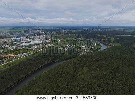 Sukhoy Log City, Pyshma River, Dark Forest And Cement Factory. Russia, Aerial, Cloudu Day