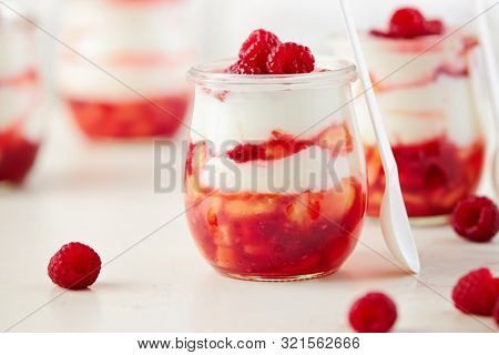 Homemade peach and raspberry dessert with yogurt cream