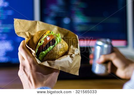 Junk Food, Fast Food And Unhealthy Food At Work Concept. No Time For Lunch. Young Software Programme
