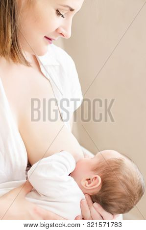 Baby Eating Breast Milk. Happy Smiling Mother Breastfeeding Her Baby Boy. Concept Of Lactation.
