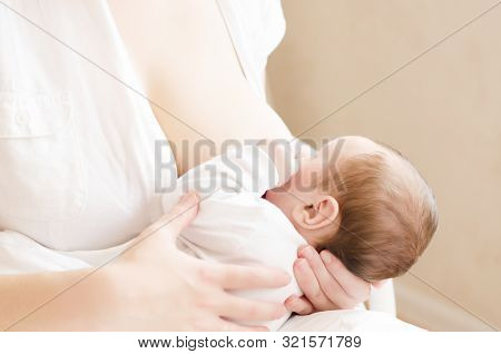 Baby Eating Breast Milk. Mother Breastfeeding Her Baby Boy. Concept Of Lactation.