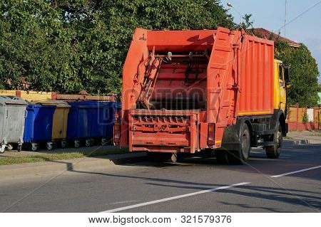 The Mechanical Garbage Truck Near Garbage Containers