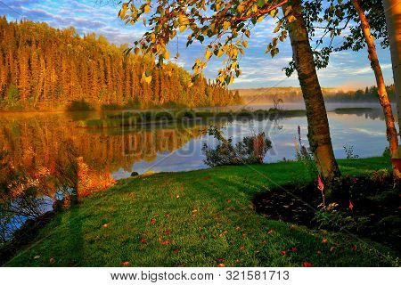 Morning Mist Over The Picturesque Lake Overlooking The Autumn Forest. Quebec, Canada.