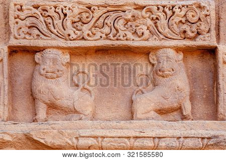 Two Lions On Relief Of Ansient Indian Temple. Artwork On Facade Of Sstone Structure Of South Indian,