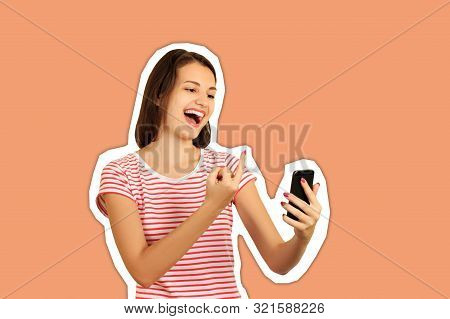 The Spiteful Smiling Girl Shows The Middle Finger In The Phone. Fuck You Sign. Emotional Girl Magazi
