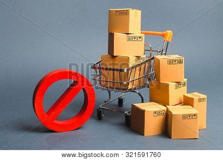 Cardboard Boxes, Supermarket Trolley And Red Symbol No. Embargo, Trade Wars. Restriction On The Impo