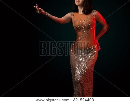 The Body Of A Beautiful Girl In A Bead Costume For Belly Dance On A Black Background. Sexy Woman Dan