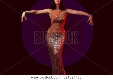 The Body Of A Beautiful Girl In A Bead Costume For Belly Dance On A Black Background. Sexy Woman Dan