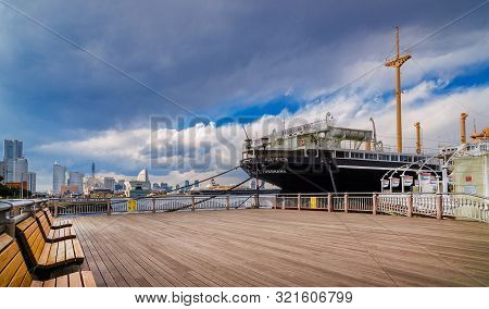 Yokohama, Japan - April 2: View Of Minato Mirai Skyline And The Famous Hikawa Maru Ship On A Dull Da