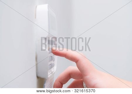 Woman Hand Entering Alarm System Password Of An Apartment, House Of Business Office. Surveillance An