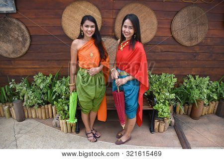Kanchanaburi, Thailand, 09.09.2019: Beautiful Thai Girls In Traditional Thai, Siamese Dress With Gre