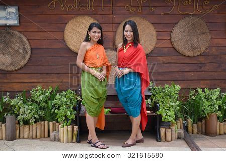 Kanchanaburi, Thailand, 09.09.2019: Beautiful Thai Girls In Traditional Thai, Siamese Dress With Gre