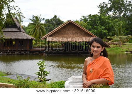 Kanchanaburi, Thailand, 09.09.2019: Beautiful Thai Girl In Traditional Thai, Siamese Dress With Gree