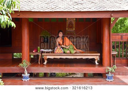 Kanchanaburi, Thailand, 09.09.2019: Beautiful Thai Girl In Traditional Thai, Siamese Dress With Gree