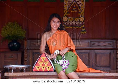 Kanchanaburi, Thailand, 09.09.2019: Beautiful Thai Girl In Traditional Thai, Siamese Dress With Gree