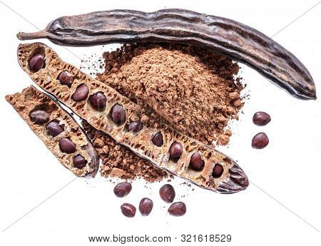 Carob pods and carob powder on the white background.