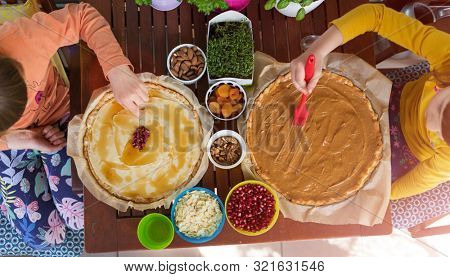 Children decorating mazurek (Polish Easter cake)

