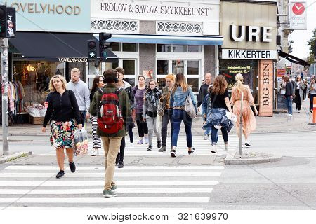 Copenhagen, Denmark - September 4, 2019: Pedestrians Crossing A Street Near The Norreport Station.