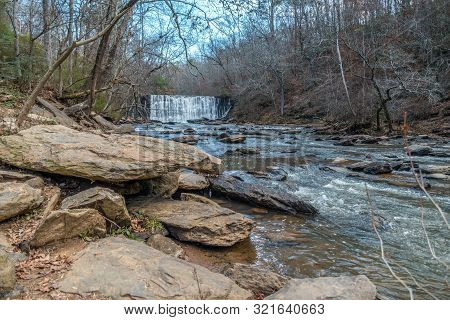 Standing Downstream Looking At The Waterfall Spilling Into The Creek At The Old Mill Park In Roswell