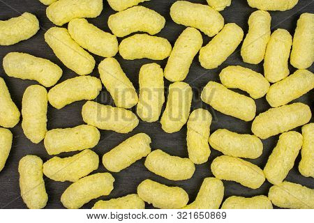 Lot Of Whole Salted Yellow Corn Puff Flatlay On Grey Stone