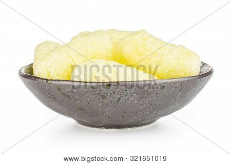 Lot Of Whole Salted Yellow Corn Puff In Dark Ceramic Bowl Isolated On White Background