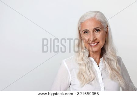 Portrait Of Beautiful Mature Woman On Light Background, Space For Text