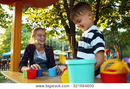 Teen Nanny And Cute Little Boy Playing Outdoors