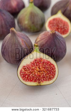Fresh Figs. Whole Figs And Sliced In Half Figs In Ceramic Bowl.