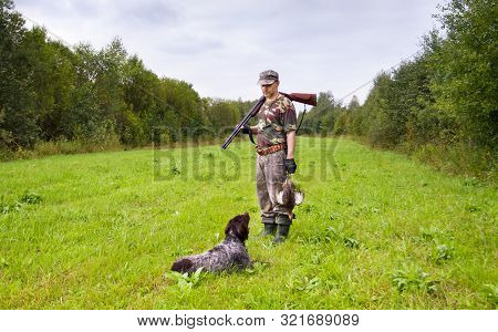 Gundog Lies In Front Of Hunter During Hunting