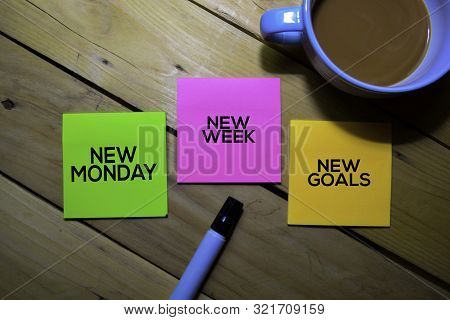 New Monday New Week New Goals Text On Sticky Notes Isolated On Table Background