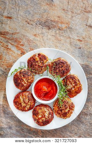 Crepinette, Fried Flat Sausages Consisting Of Minced Meat, French Meatballs, Served On A  White Plat