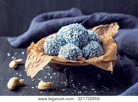 Energy balls with nuts, hemp hearts, blue spirulina and shredded coconut