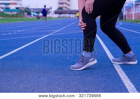 Knee Injuries. Young Sport Woman Holding Knee With Her Hands In Pain After Suffering Muscle Injury D